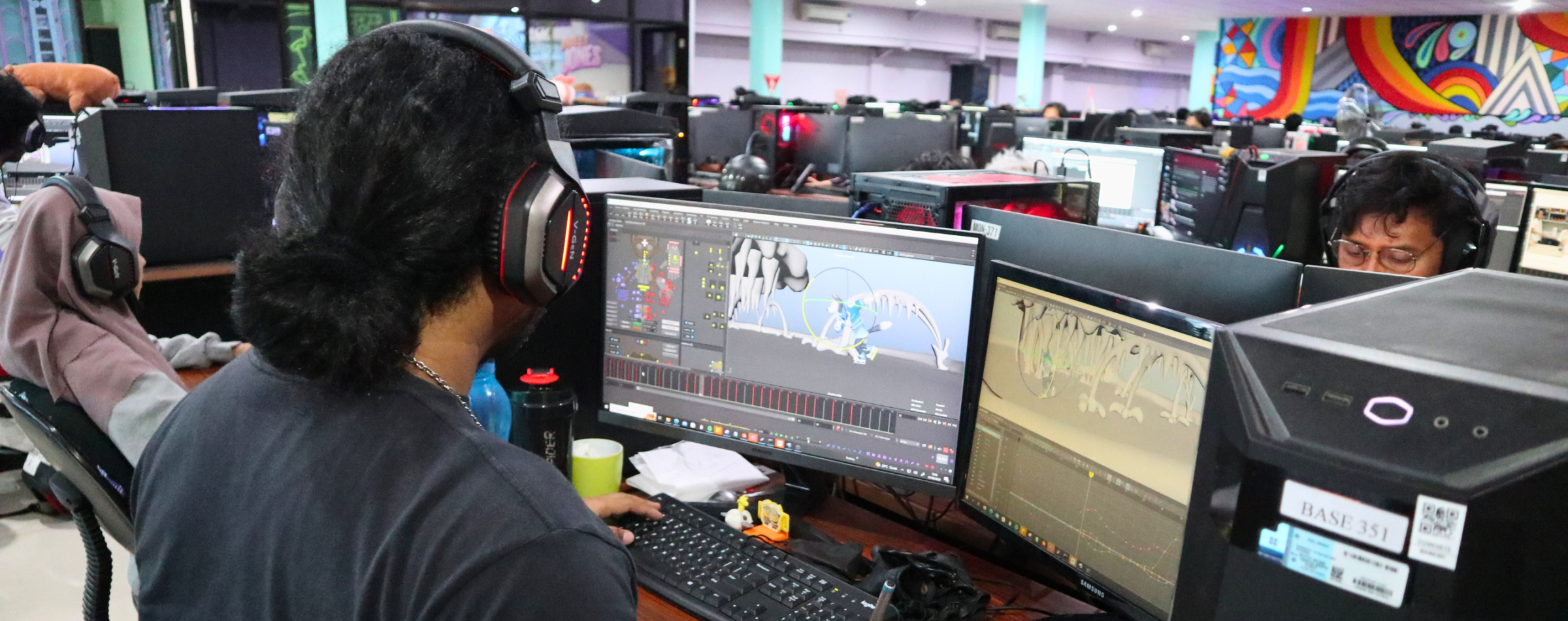 A photo of our studio location in Brown Bag Films Bali featuring people working on animation wearing headphones