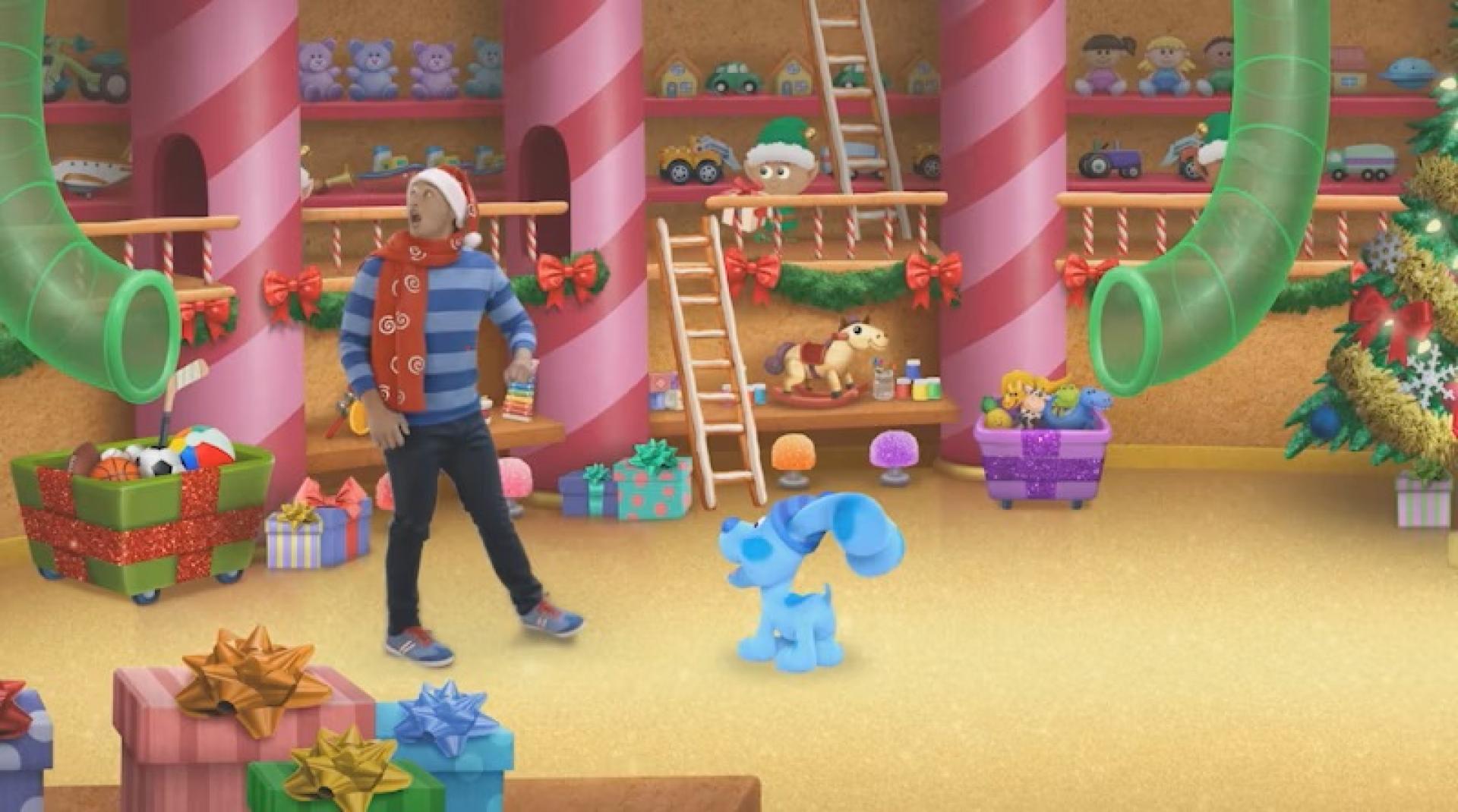 Blue and Josh standing in Santa’s workshop filled with candy cane pillars, gifts, and toys.