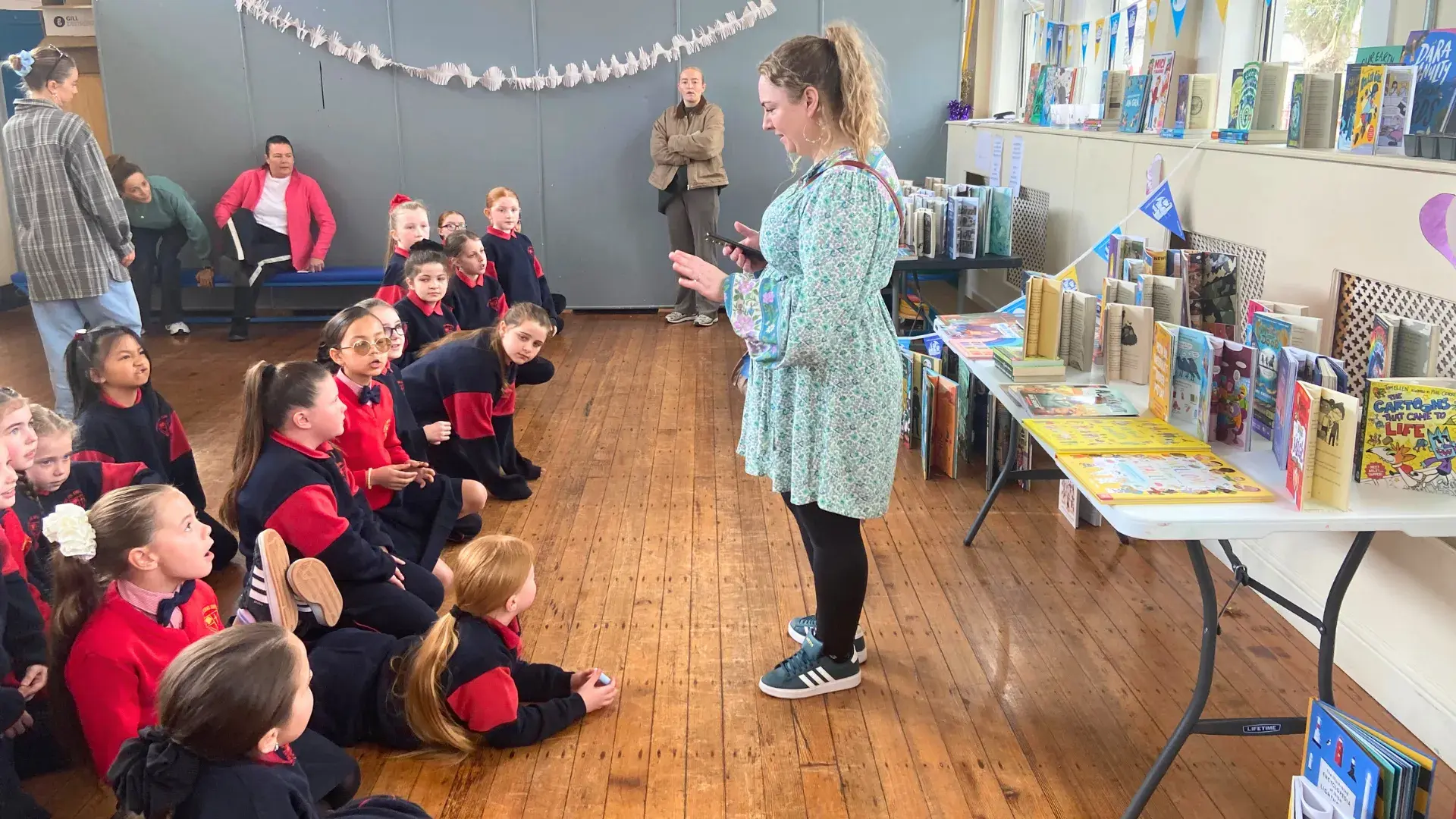 A member of Children's Books Ireland introducing the students to their new library books