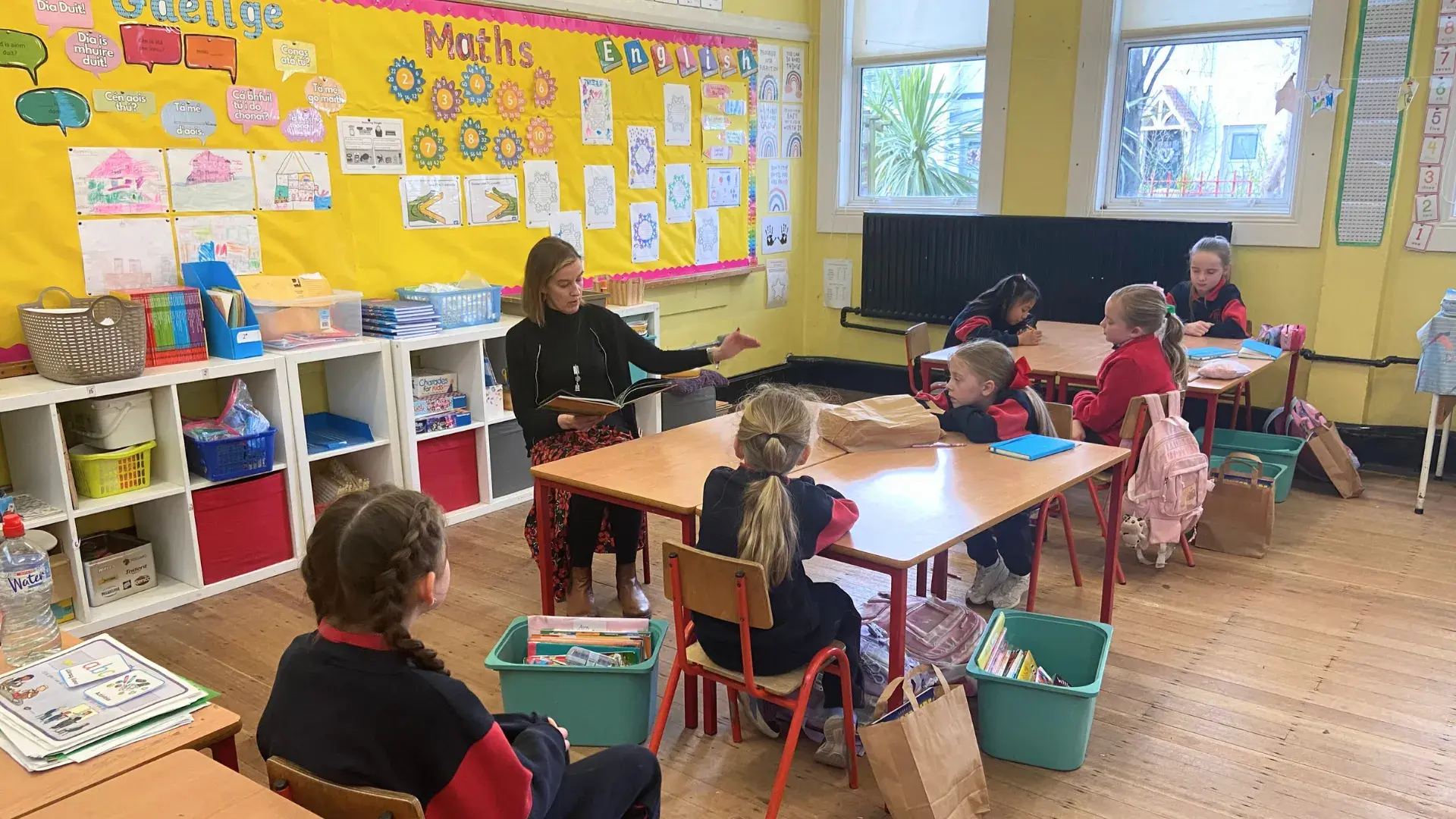 A children's book author giving a reading in a school classroom