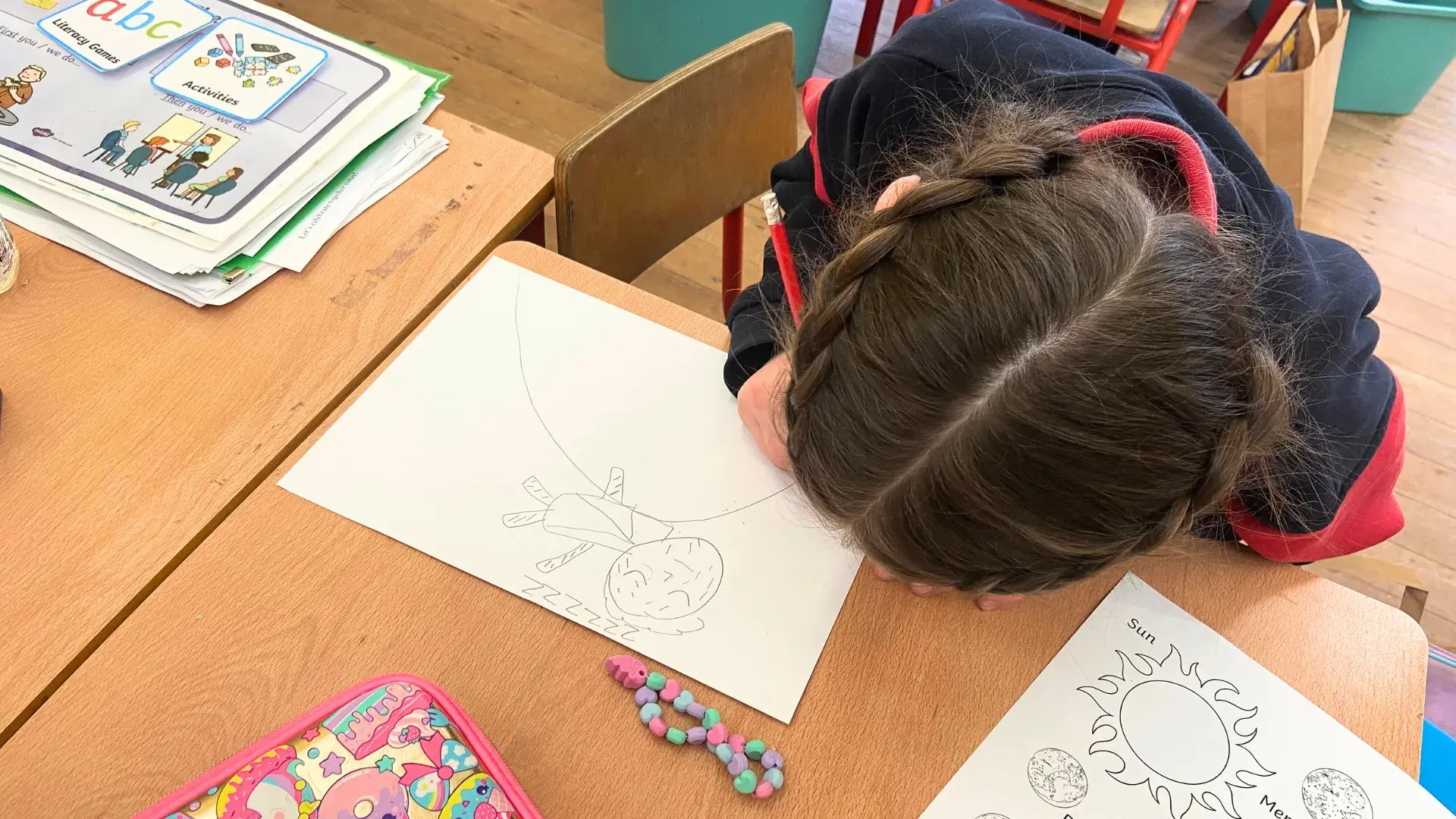Child in classroom drawing