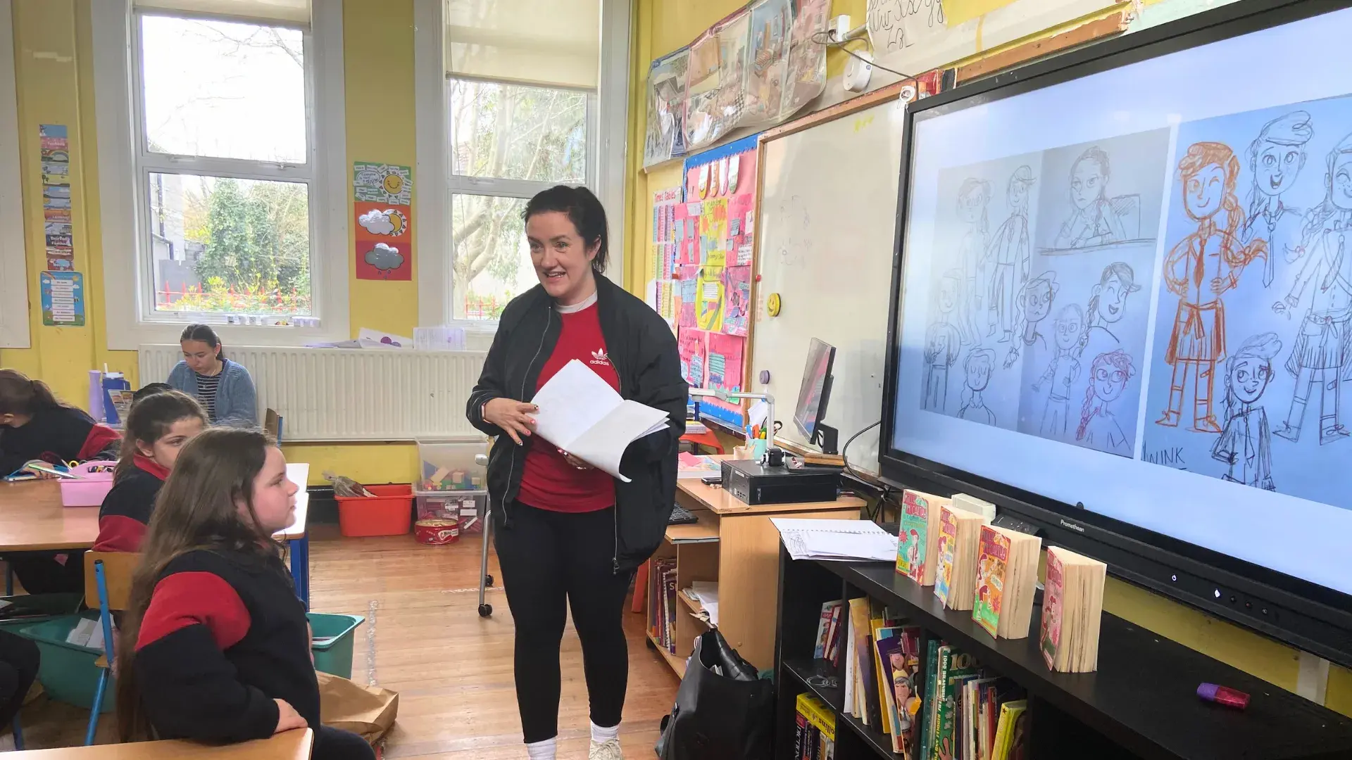 A children's book author giving a presentation in a school classroom