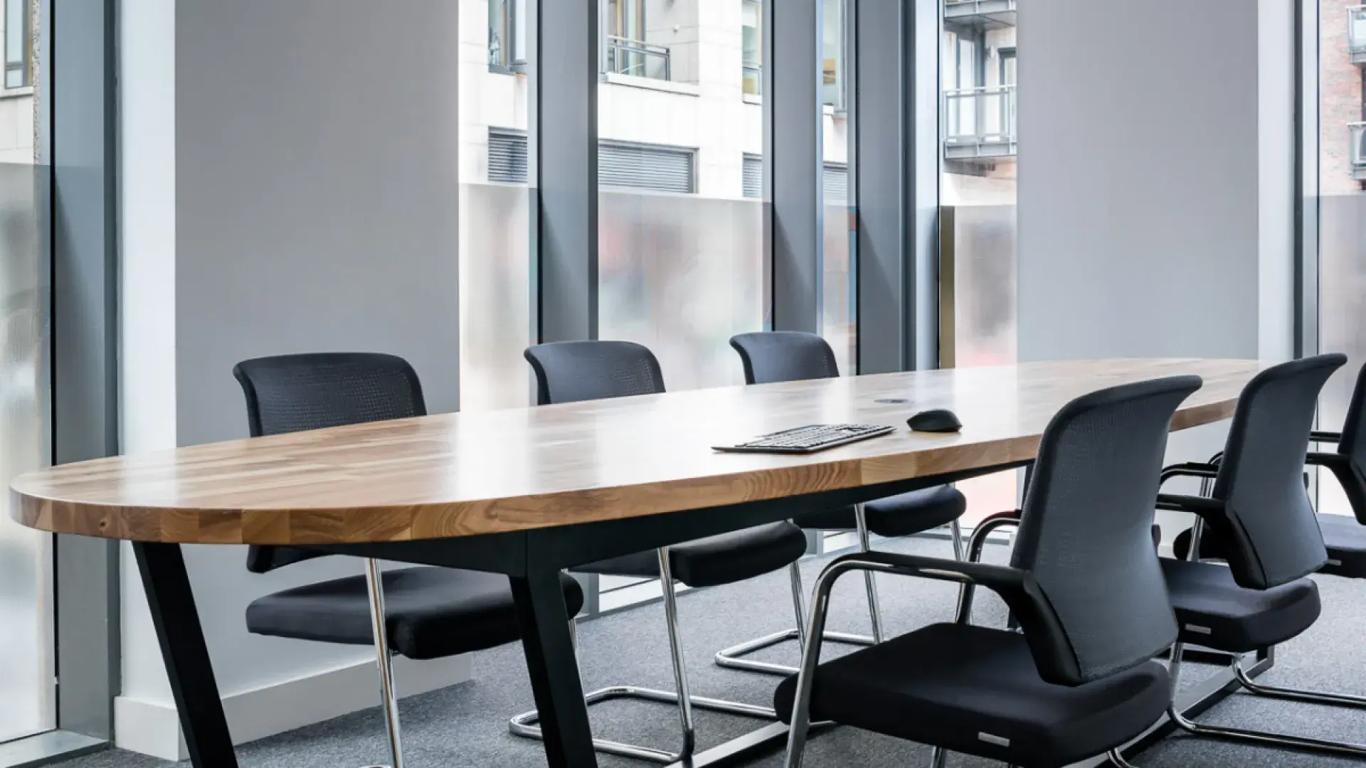 A photo of the Brown Bag Films' Dublin studio Board Room, with a long oval table and chairs around it.