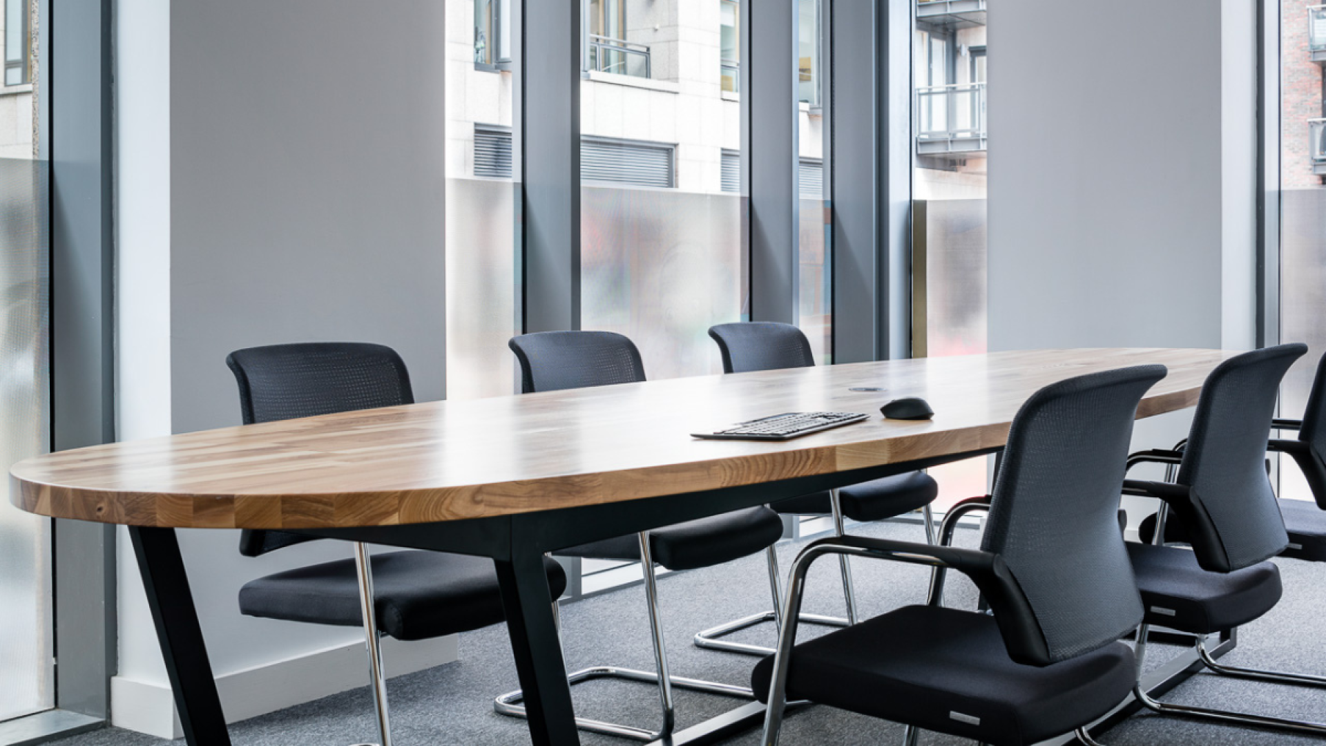 A photo of the Brown Bag Films' Dublin studio Board Room, with a long oval table and chairs around it.