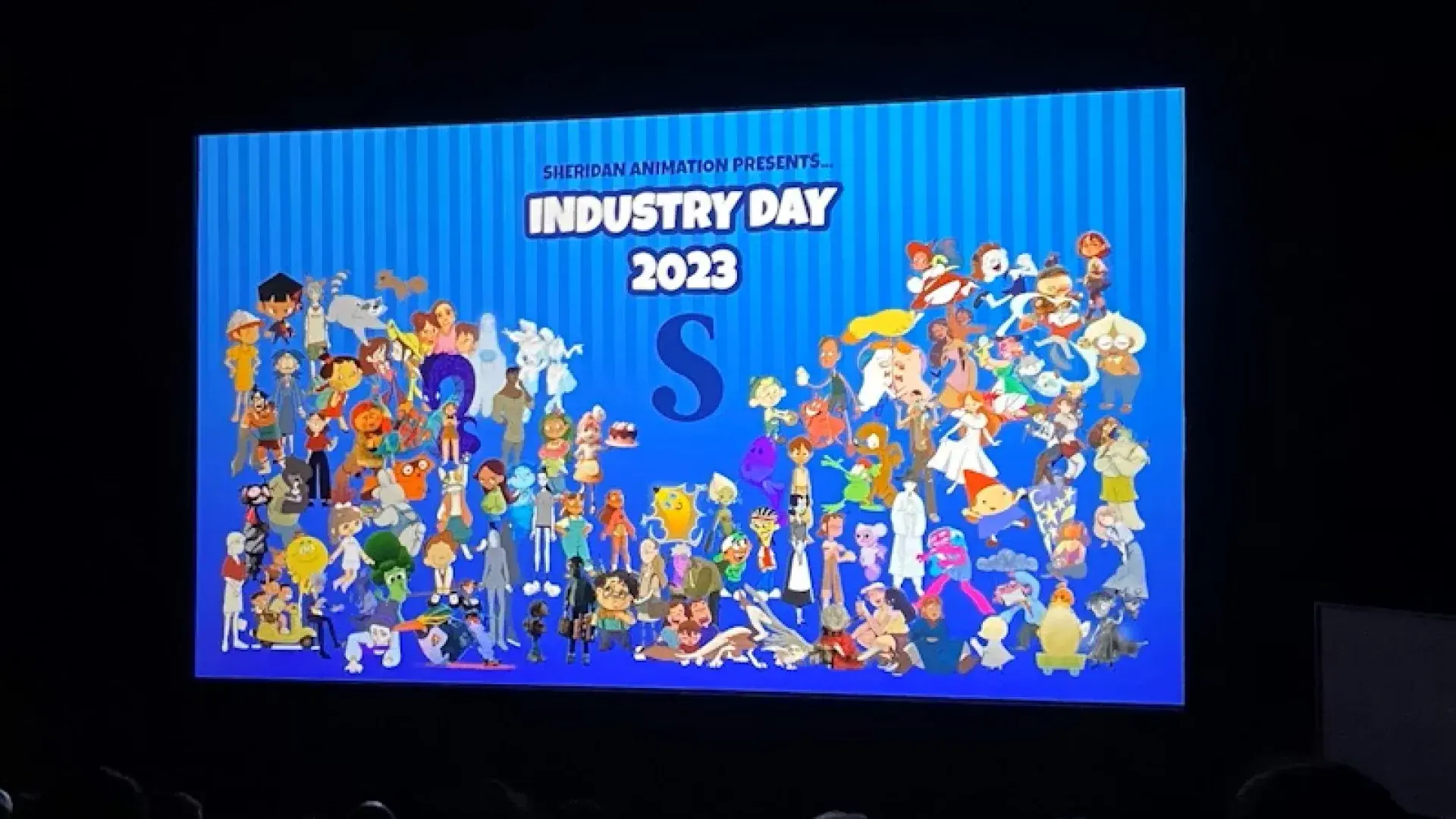 Presentation screen displaying colorful cartoon characters with text “Sheridan Animation Presents Industry Day 2023.”