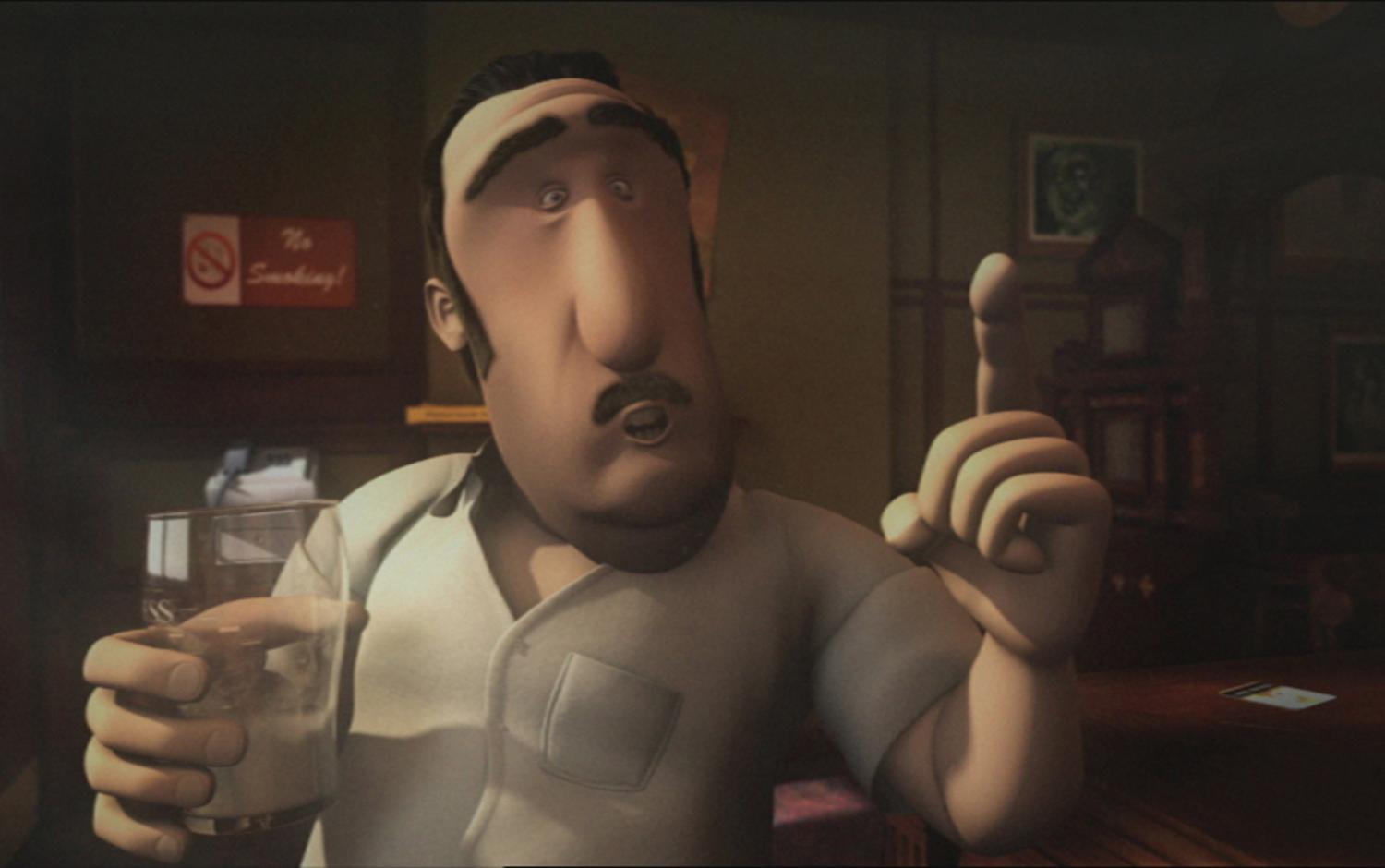 Bartender Denny holding a pint glass and gesturing with his hand.