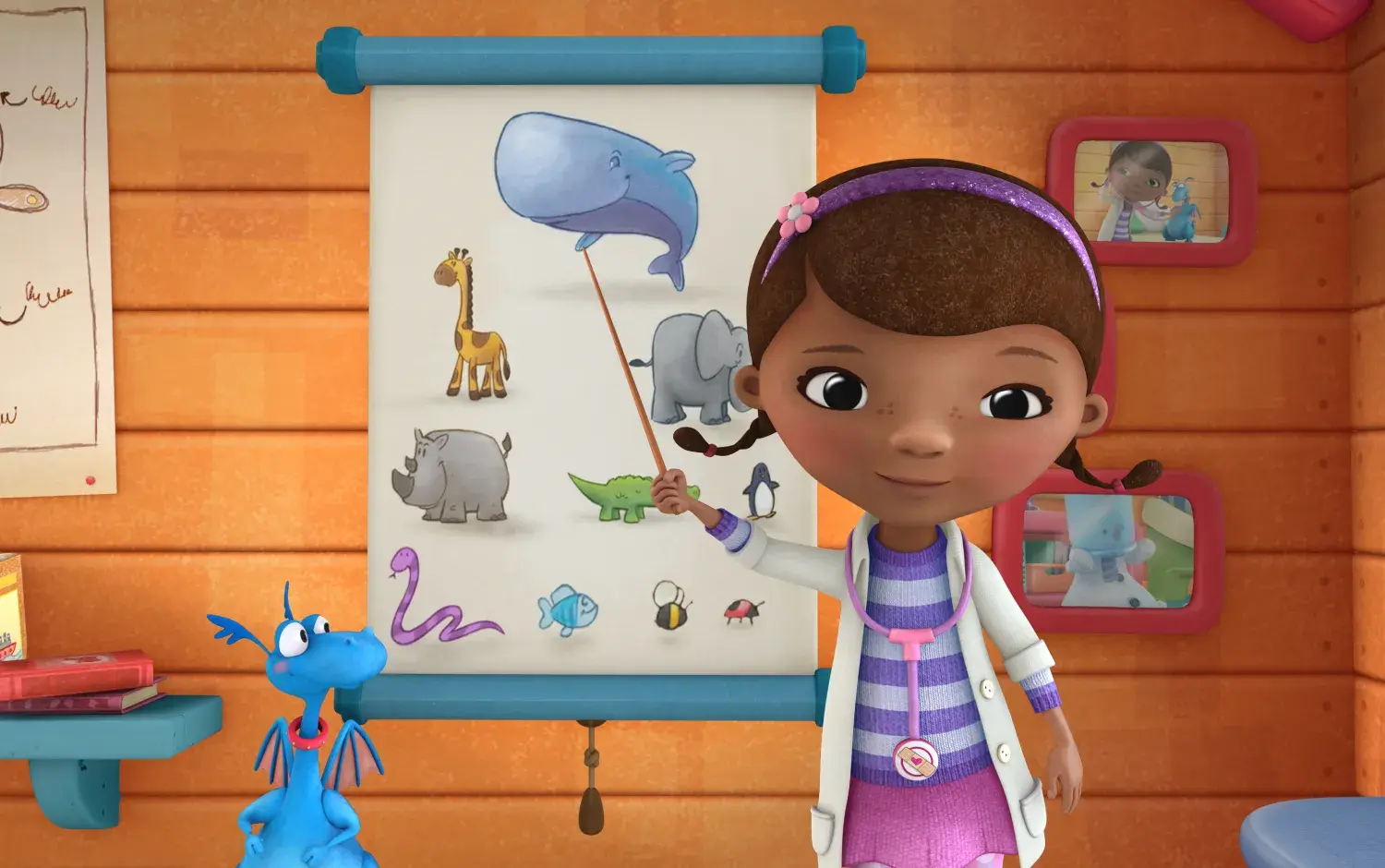 Doc McStuffins pointing at a picture of a whale on a chart