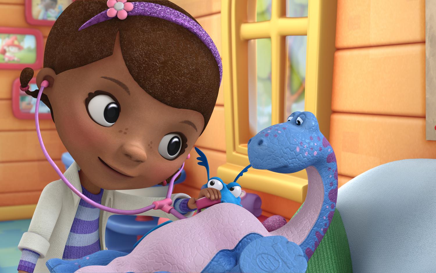 Doc McStuffins giving a check-up to a dino toy
