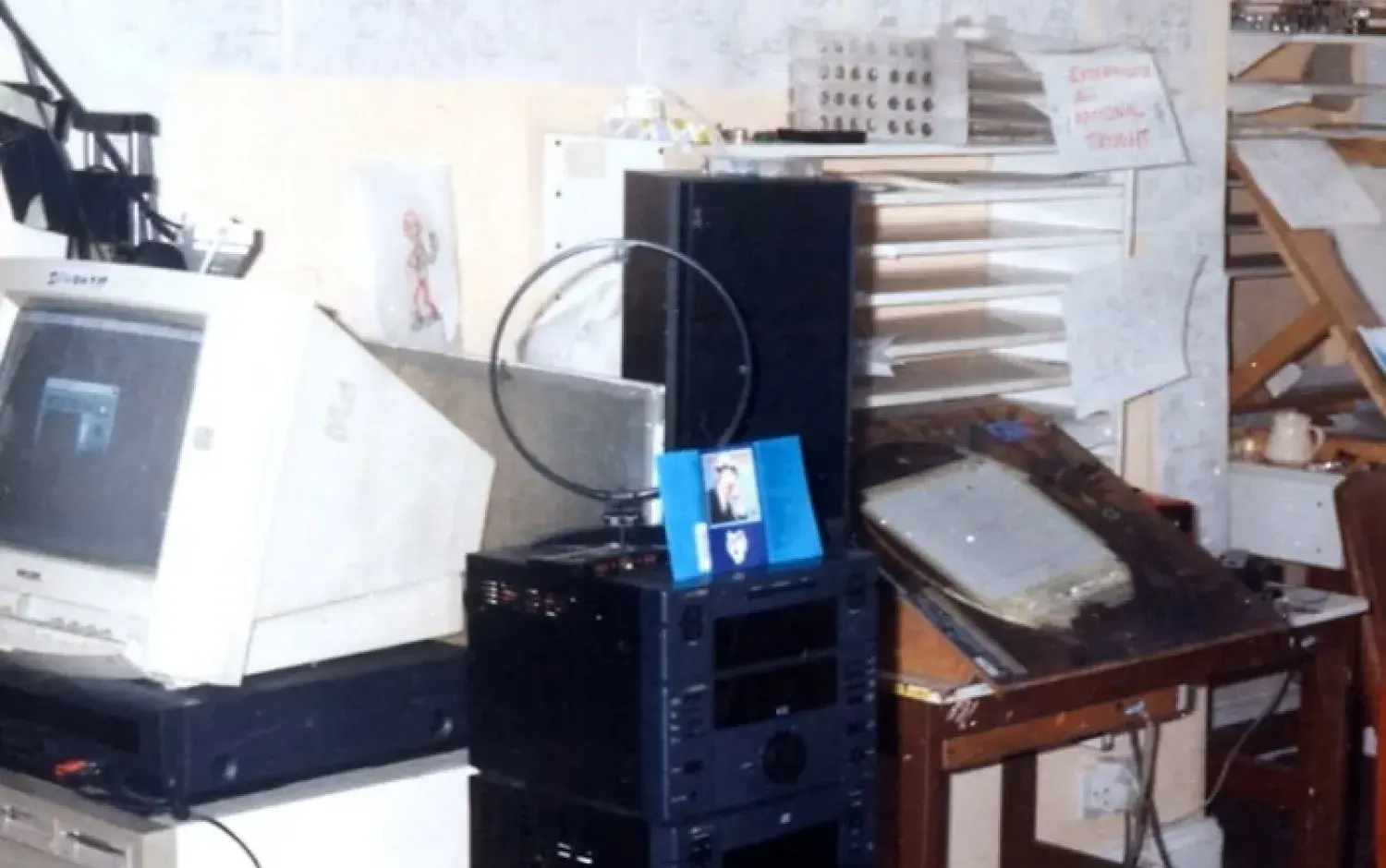 A desk in 1995 cluttered with electronic equipment and papers for digital design.