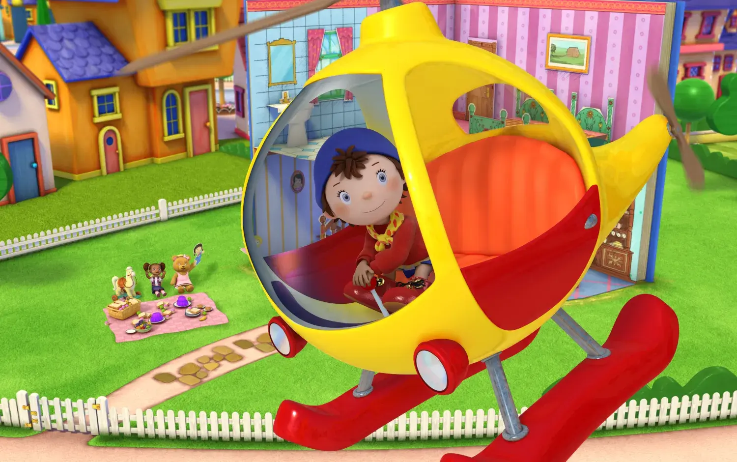 Noddy in a yellow and red helicopter soaring above Toyland