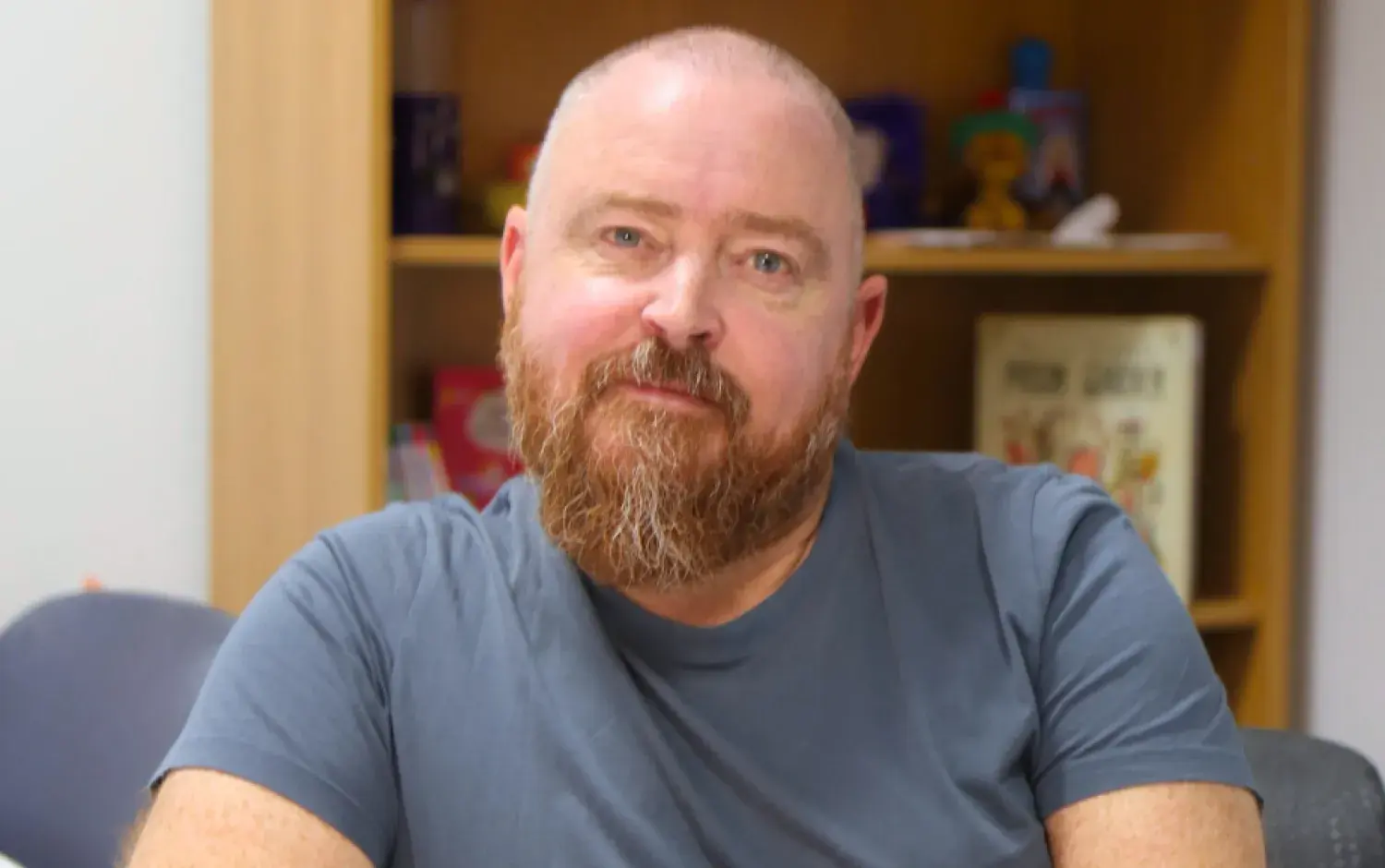 A photo of Darragh O'Connell, bookshelves in the background