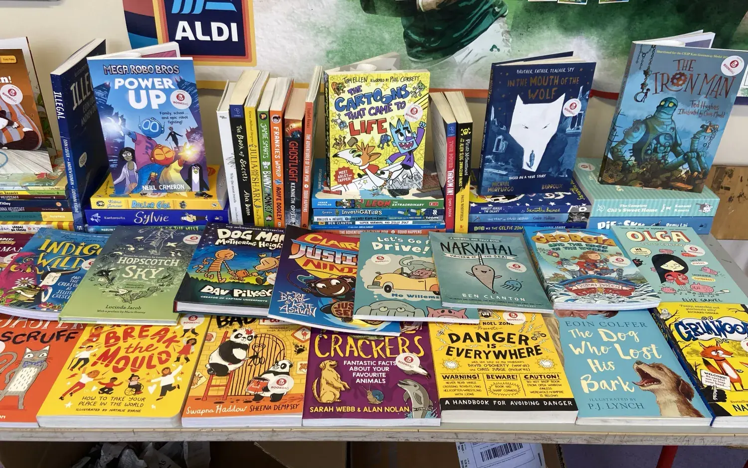 Table display of children’s books including illustrated titles on creativity and adventure.