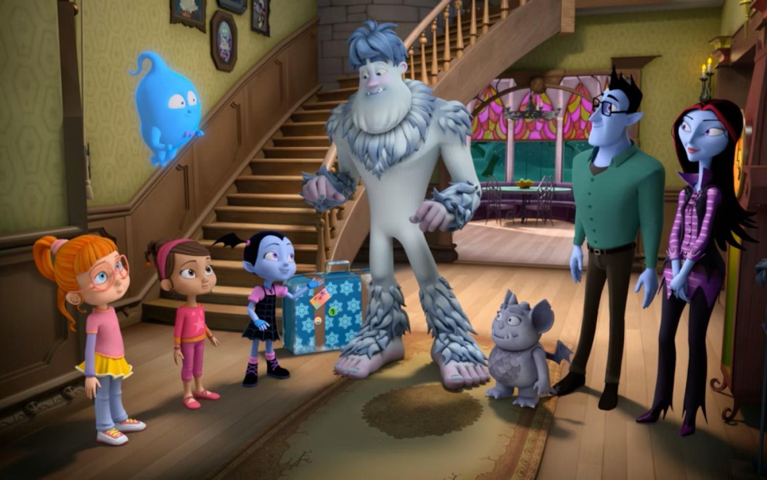 Animated characters from Vampirina gathered in a spooky-themed living room with a staircase, featuring a yeti holding a wrapped gift, a ghost floating nearby, and other family and friends in a festive setting.
