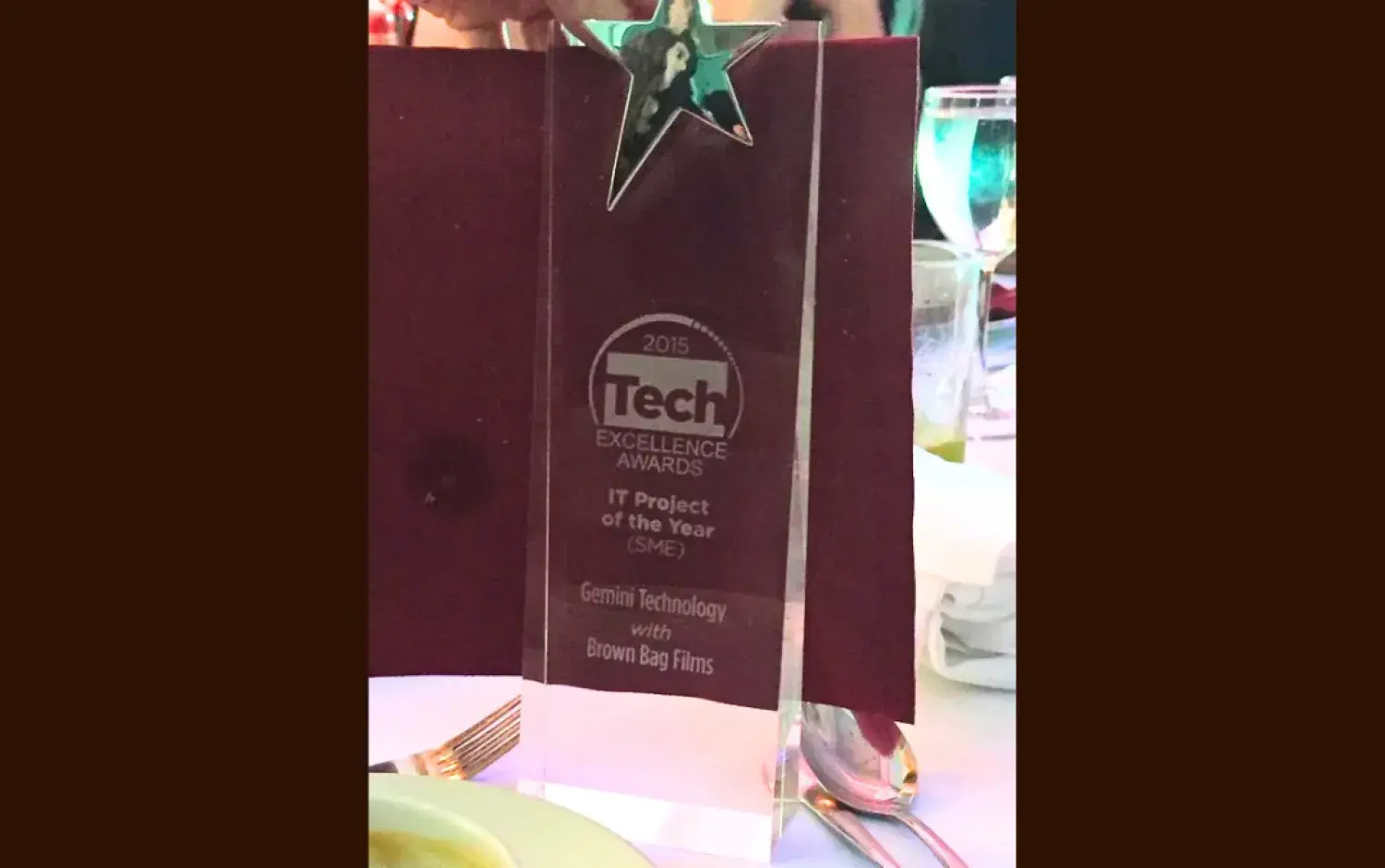 Clear acrylic award with a star on top, labeled “Tech Excellence Awards 2015 – IT Project of the Year.”