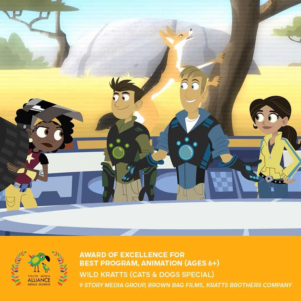 Animated Wild Kratts characters in creature power suits standing at a console with a fox in the background.