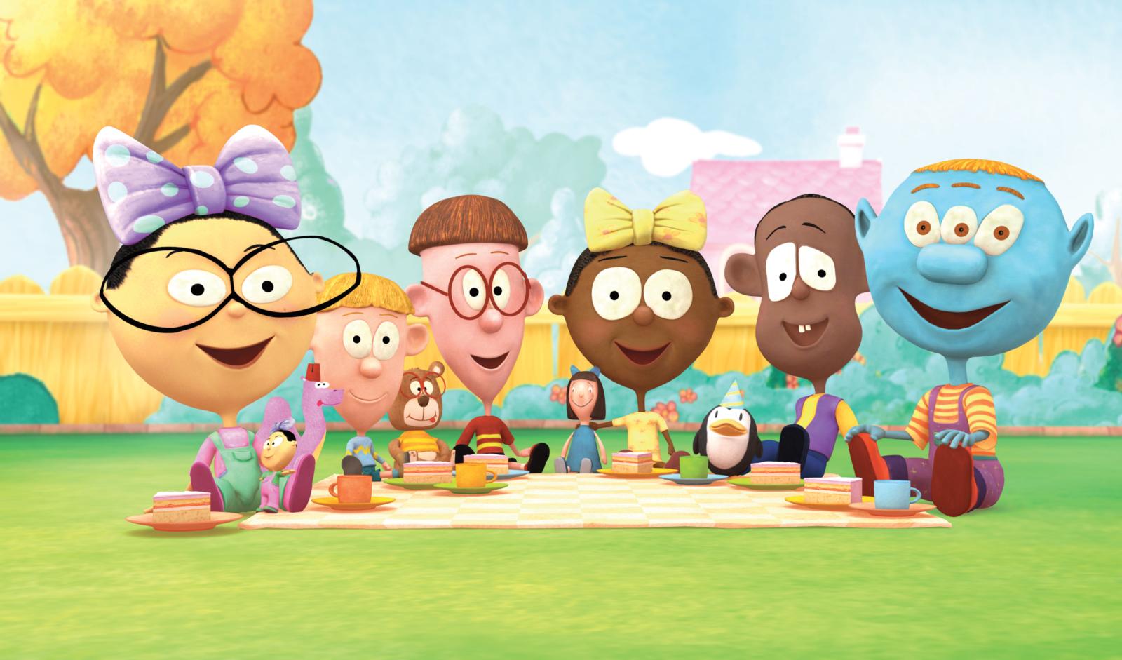 Group of animated characters having a picnic on a blanket in a sunny garden with teacups, plates, and autumn trees in the background.