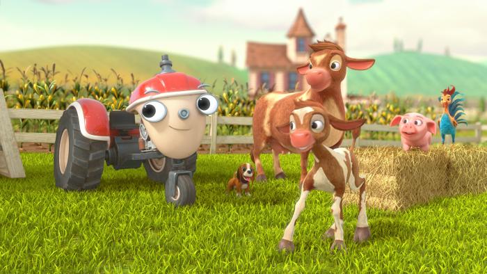 Otis next to a cow and her calf, with the farm in the background