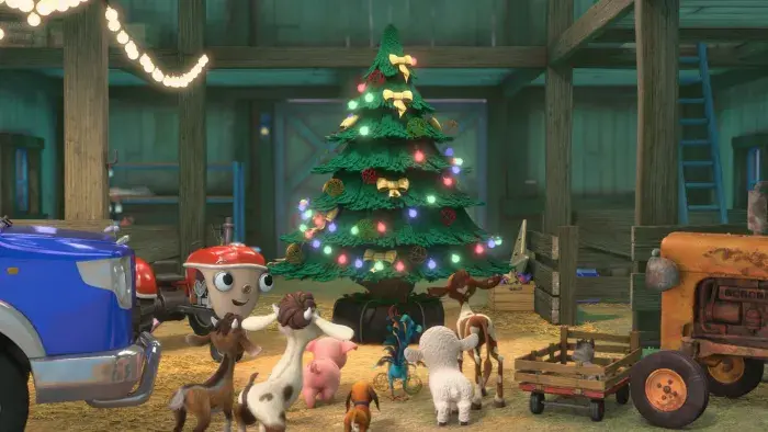 Otis and his friends around a lit up Christmas tree