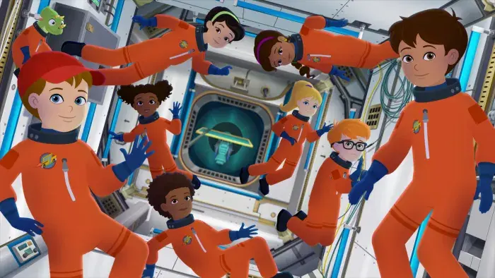 Magic School Bus: Rides Again: Students in orange space suits float inside a spacecraft.
