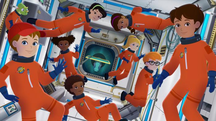 Magic School Bus: Rides Again: Students in orange space suits float inside a spacecraft.