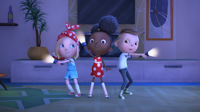 Rosie, Ada and Iggy holding flashlights in the dark