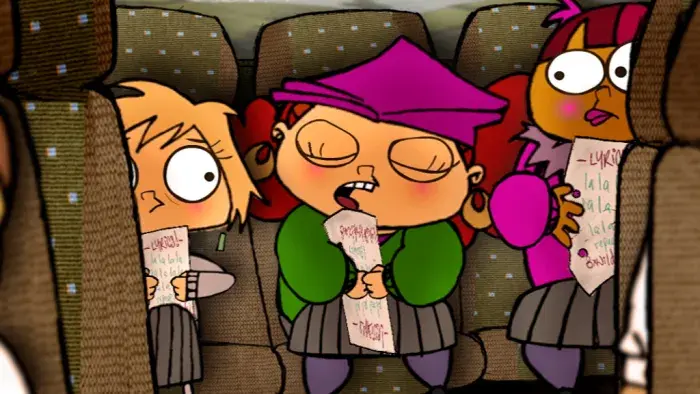 A group of girls singing while sitting at the back of a bus.