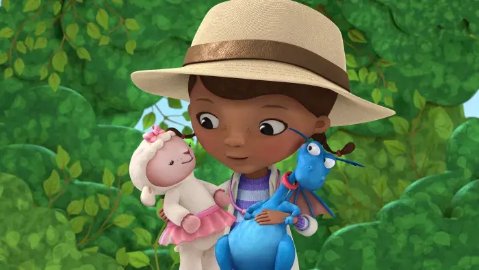Doc McStuffins holding Lambie and Stuffy.
