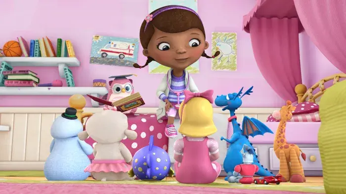 Doc McStuffins with her toy friends sitting around her in her room