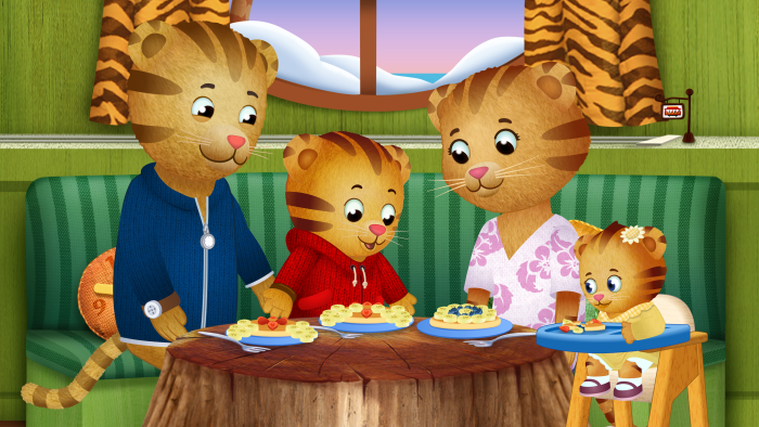 Daniel Tiger's Neighborhood: Daniel sits at a table while a friend feeds a baby.