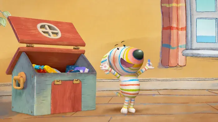 Dylan's Playtime Adventures: A character stands beside an open toy chest filled with colorful toys.