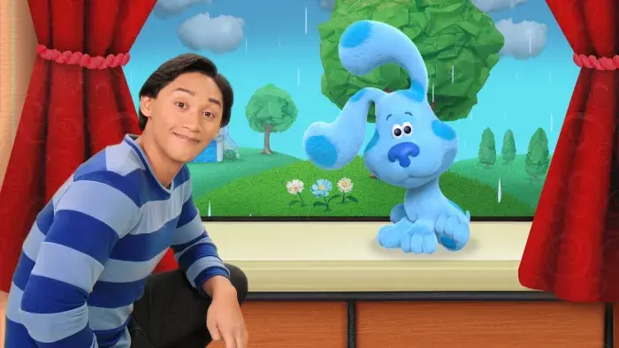 Blue's Clues & You: Josh and Blue look out the window with red curtains in the background.