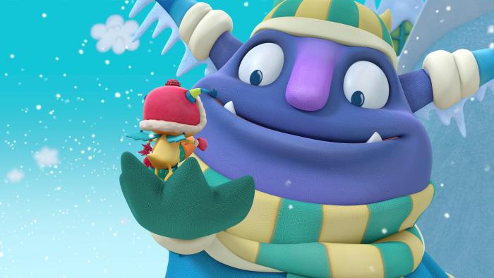 A giant friendly monster holding Henry in his palm