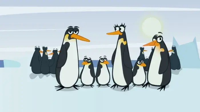 a group of penguins standing together on the ice