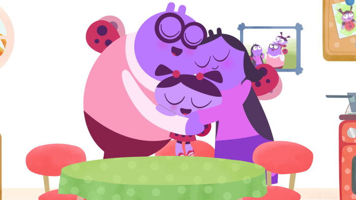 Lu & The Bally Bunch: A large purple character with glasses sits at a desk in a study room.