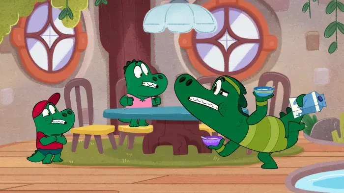 Let's Go, Bananas!: Two characters sit at a table, one looking surprised. One character stretches in front of table.