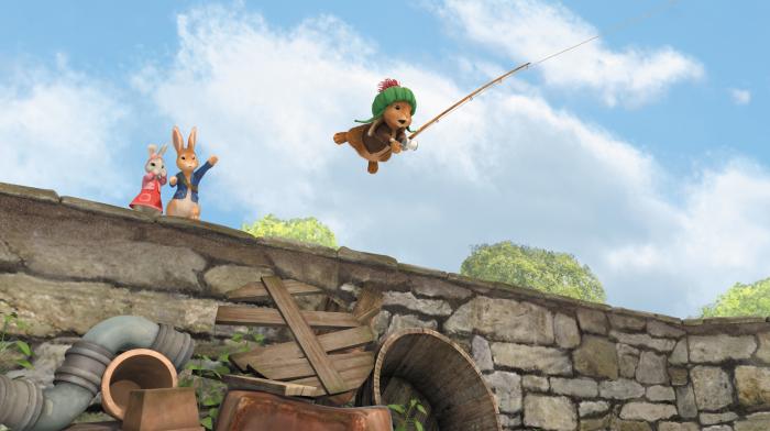 Benjamin being pulled off a bridge holding a fishing reel