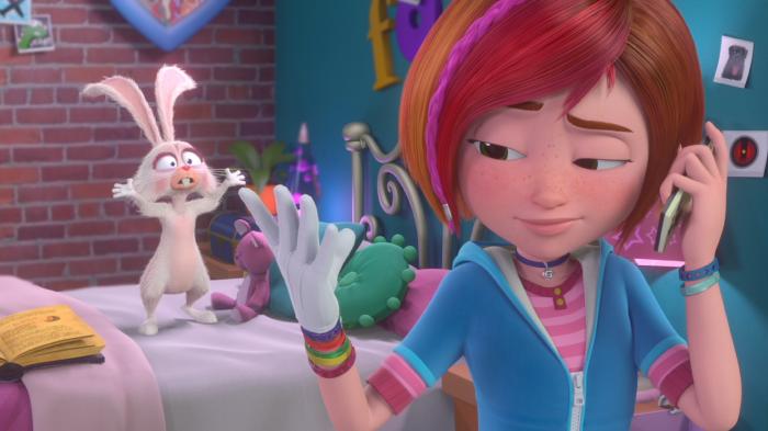 Sadie on the phone looking at her hand with Gilbert in the background looking perplexed