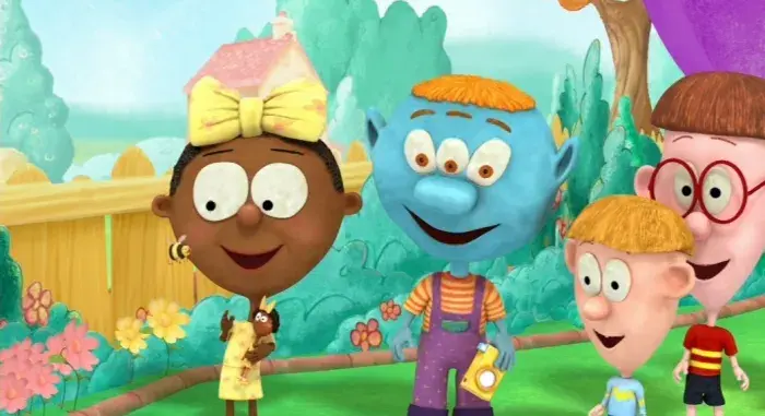 Group of animated characters in a vibrant garden with flowers, a wooden fence in the background.