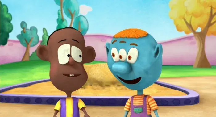 Two animated characters standing near a sandbox in a colorful park with trees and a bright sky.